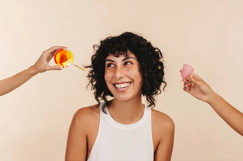 A woman looking at and choosing the Lumma menstrual disc versus other menstrual cups